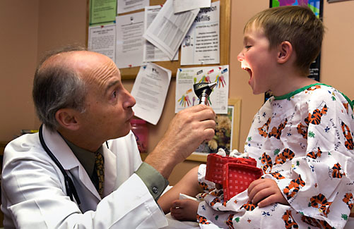 doctor with child saying ahhhh